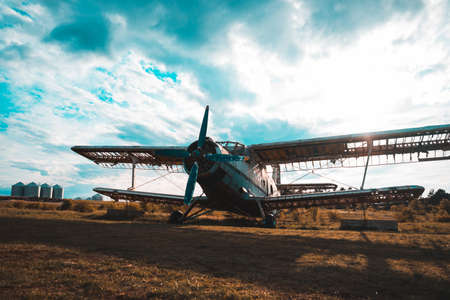 HDR foto of an old airplane on green grass and sunset backgroundの写真素材