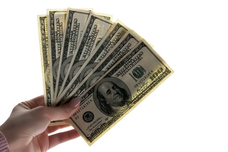 A woman's hand with dollars on a white background