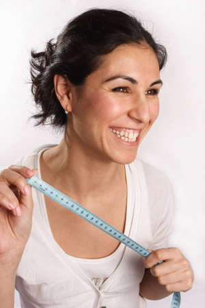 Smiling woman with tape measure in hands
