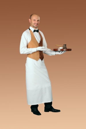 Waiter in uniform with percolator and cup of coffee  の写真素材