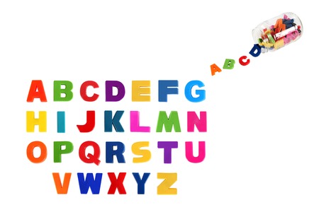 Alphabet written in multicolored plastic kids letters and colorful symbols of alphabet in glass can