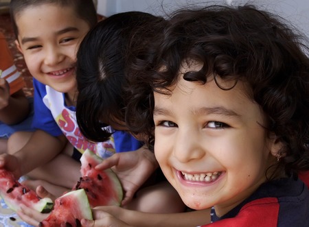 Ashgabat, Turkmenistan - July 1   Portrait of unidentified Laughing Asian girl and boy with a large watermelon   Ashgabat, Turkmenistan - July 1  2013 のeditorial素材