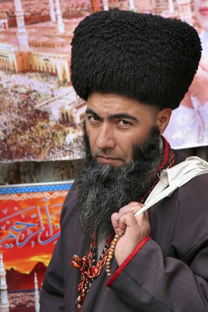 Ashgabat, Turkmenistan - February 26   Portrait of Turkmen man in telpek with bushy beard  Oriental bazaar  Ashgabat, Turkmenistan - February 26  2013  のeditorial素材