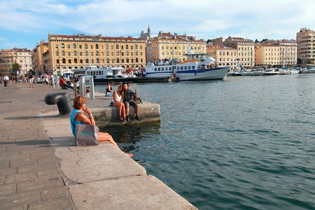 MARSEILLE - JULY 2, 2014: Old port (Vieux-Port) with people sitting on the quay on July 2, 2014, Marseille. Marseille is France's largest city on the Mediterranean coast and largest commercial port.のeditorial素材