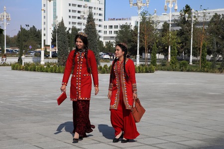 Ashgabad, Turkmenistan - October 10, 2014. Two young girls in national dress on square of on 10 October 2014.のeditorial素材