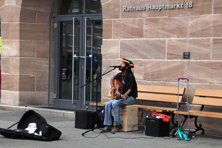 NURNBERG, GERMANY - JULY 13 2014: Hauptmarkt, the central square of Nuremberg - street musician, ...