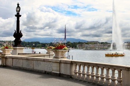 Geneva, Switzerland - JULY 12, 2014. Jet d'Eau on Lake Geneva, Switzerland with flowers in the foregroundのeditorial素材