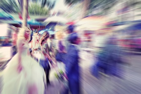 Abstract background. Blurred crowd, bride and groom on the Boulevard Montmartreon  in Paris - radial zoom blur effect defocusing filter applied の写真素材
