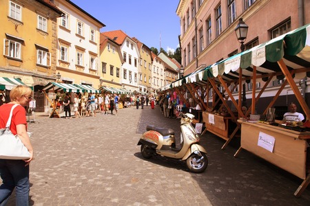 LJUBLJANA, SLOVENIA -  JUNE 28, 2014: Street in the old city center of Ljubljana with street shops and cafes. LJUBLJANA, JUNE 28, 2014.のeditorial素材