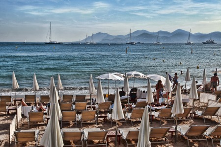 CANNES, FRANCE -  JULY 5, 2014. The beach in Cannes. Cannes located in the French Riviera. The city is famous for its Film Festival. FRANCE, - JULY 5, CANNES 2014のeditorial素材