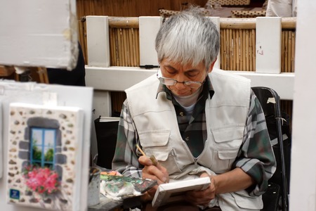 PARIS, FRANCE - August 19, 2014. Artists easels and artwork set up in Place du Tertre in Montmartre. Montmartre attracted many famous modern artists including Picasso and Dali. PARIS, FRANCE - August 19, 2014.のeditorial素材