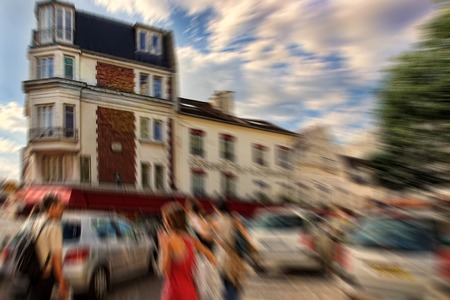 Abstract background. Tourists walking on Montmartre.  Blur effect defocusing filter applied, with vintage instagram look.のeditorial素材