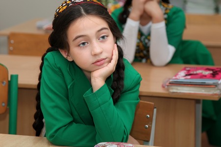 Ashgabad, Turkmenistan - November 4, 2014. Portrait of an unknown schoolgirl in the classroom.のeditorial素材