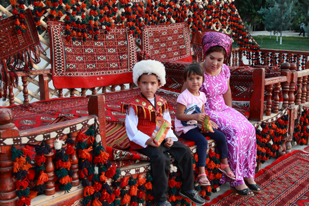 Ashgabat, Turkmenistan - September, 12, 2017. Unknown Turkmen family with children.  Boy in traditional national  clothes. のeditorial素材