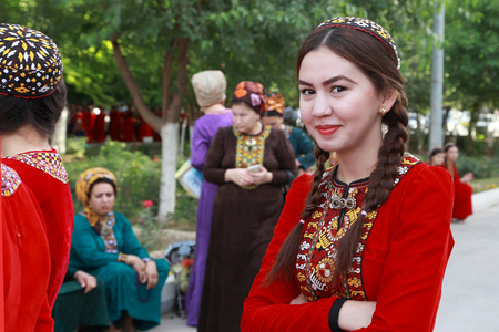 Ashgabat, Turkmenistan, May 25, 2017: Portrait of an unknown female student in a red national dress with embroidery.  Ashgabat, Turkmenistan, May 25, 2017のeditorial素材