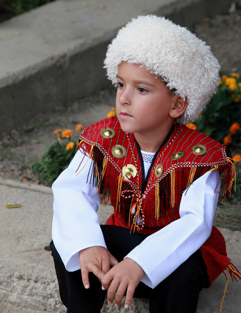 Ashgabat, Turkmenistan - September, 12, 2017.  Portrait of  unidentified serious  Asian boy.  Boy in traditional national  clothes. のeditorial素材