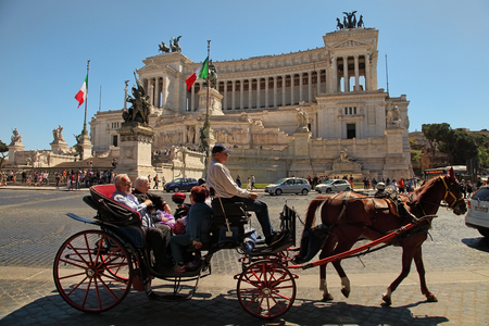 Rome, Italy - APRIL 11, 2017 : Tourist coach with horses in Piazza Venezia and Monumento Nazionale a Vittorio Emanuele II. Rome, Italy - APRIL 11, 2017.のeditorial素材