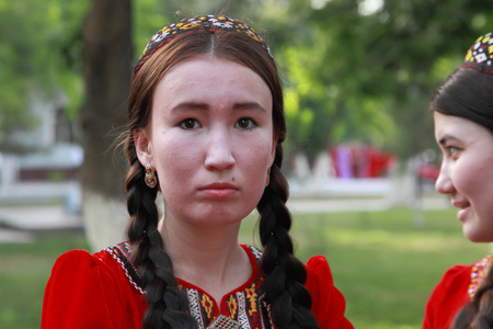 Ashgabat, Turkmenistan, May 25, 2017: Portrait of an unknown female student in a red national dress with embroidery.  Ashgabat, Turkmenistan, May 25, 2017のeditorial素材