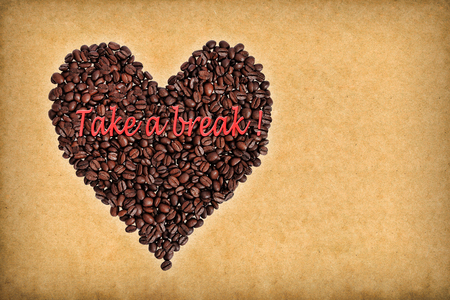 Heart composed of coffee beans. Inscription  "Take a break!"  Concept of coffee in retro style.の写真素材