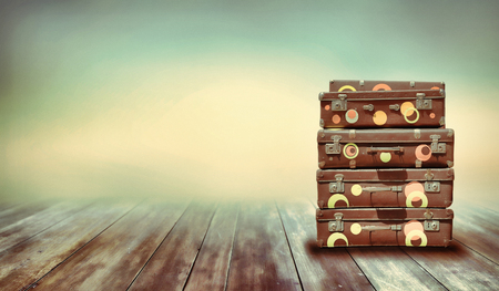 Shabby Vintage Ancient Suitcases. Background of wooden boards. Travel Concept .の写真素材
