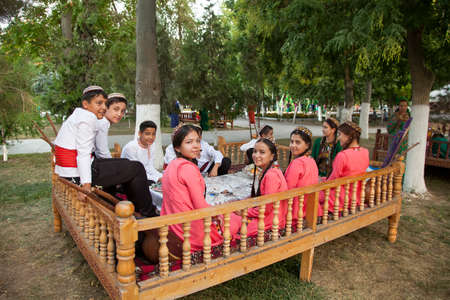 Ashgabat, Turkmenistan - August, 14, 2019: Group of young musicians in traditional national  clothes before the performance at the Kurban-Bairam Festival. August, 14, 2019. Ashgabatのeditorial素材