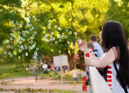 Kryvyi Rig, Ukraine - June 01, 2015: Girl blow bubbles in the flashmob dedicated to Children's Day on June 01, 2015 in Kryvyi Rig, Ukraineのeditorial素材