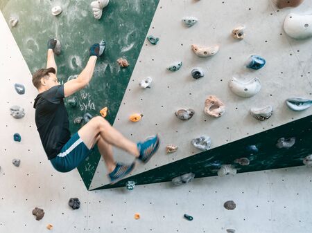 Man climbing bouldering problem. Rock-climbing icon. Man climbing in motion. Climbing background.の写真素材