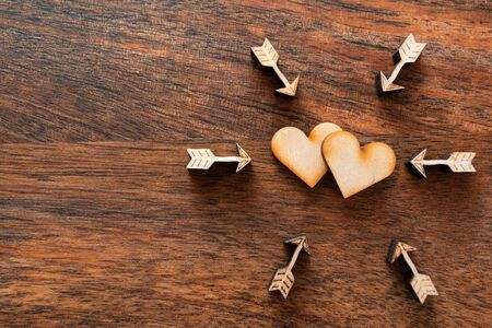 valentine day love beautiful wooden background. Love wooden hearts, arrows Flat lay, top view, copy space.の写真素材