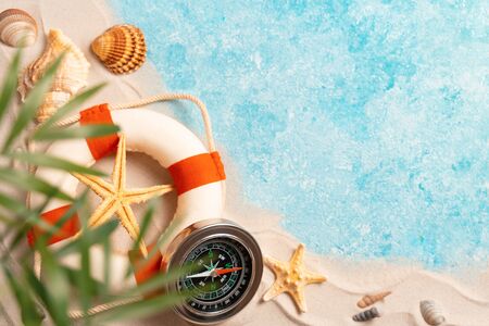 Creative layout of sand waves and sea, summer beach background with shell, sea star, compass life preserver and blurred Palm, vacation and travel concept, Flat lay top view copy space, exotic concept.の写真素材