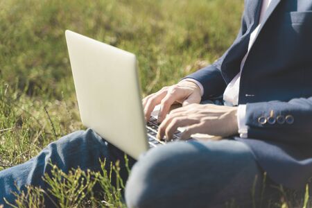 Work outside concept. Soft focus laptop in nature background. Ecology travel and work outside office concept.の写真素材