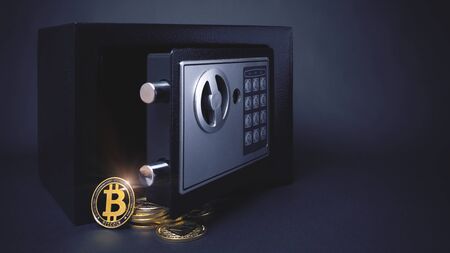 Safe Deposit. Symbol of cryptocurrency safety. Small Residential Vault with physical bitcoin. Toned soft focus picture. Copy spaceの写真素材