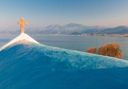 Church on Crete island beach and mountains in the evening time. Greece vacation.