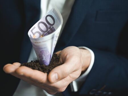 500 euro growing money in businessman hands. Investment And Interest Concept. businessman protects...