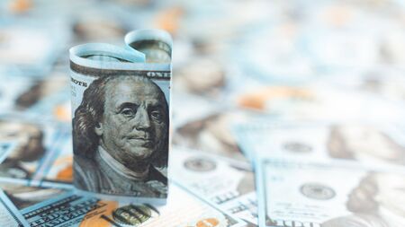 dollar bill in form of heart in dollars background - as symbol of love, success and wealth. Copy...