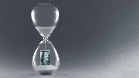 Hourglass on dark background. Concept passing traditional currency time. End of dollar currency. Copy space.の写真素材
