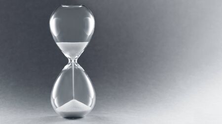 Hourglass with copy space. Symbol of passing time, concept for business deadline, urgency and running out of time.の写真素材