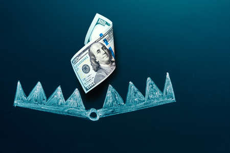 Trapped concept. US 100 dollar bill as a bait. American currency into the bear trap. Investment risk...