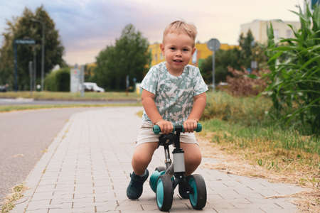 Boy on a bike. Child on balance bike riding on a bike path. Concept of healthy lifestyle, childhoodの写真素材