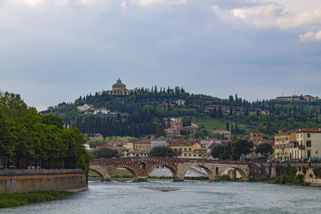 Verona Skyline with an bridge over the Adige River. Bright cityscape with a bend in the river and a...