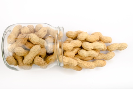 A jar of roasted peanuts in shellの写真素材