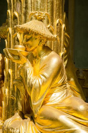Single golden statue in front the Chinese house, part of Sanssouci park  18th century   Sanssouci is the former summer palace of Frederick the Great, King of Prussia のeditorial素材