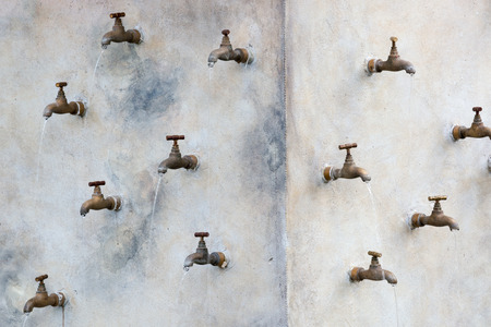 Group of water taps mounted on the wall