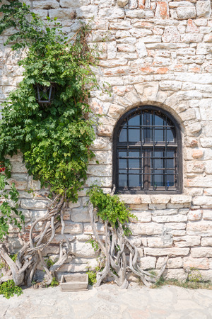 Old wooden window on stonewall, Balchik, Bulgariaのeditorial素材
