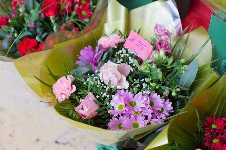 Bouquet of pink flowers roses, carnations, gypsophila, chrysanthemums in the shop. Retail street sale near metro station for Valentine's Day on February 14 or International Women's Day on March 8.の写真素材