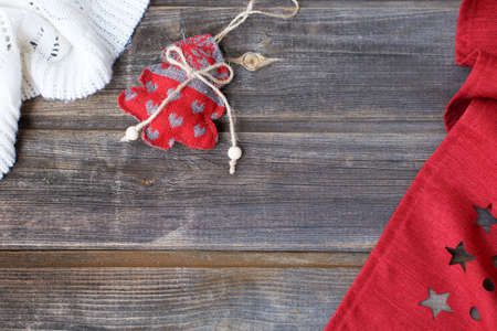 New year flat lay: christmas linen tree with hearts, white woolen plaid and red tablecloth with...