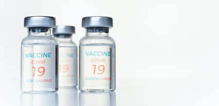 Closeup transparent vials with new vaccine for covid-19 coronavirus, flu, infectious diseases....