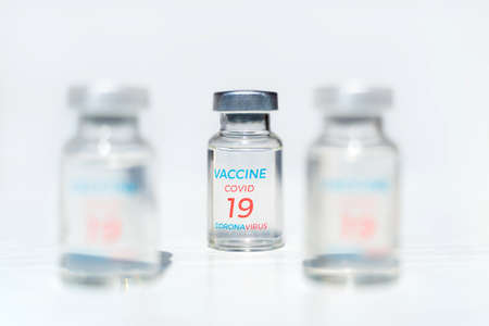 Closeup transparent vials with new vaccine for covid-19 coronavirus, flu, infectious diseases. Injection after clinical trials for vaccination of human, child, adult, senior. Medicine, drug concept.の写真素材