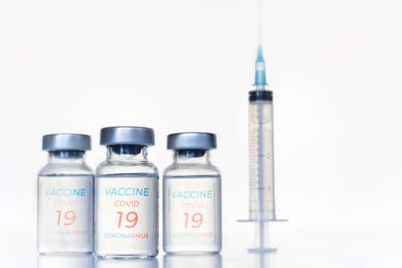 Transparent vials, syringe with new vaccine for covid-19 coronavirus, flu, infectious diseases. Injection after clinical trials for vaccination of human, child, adult, senior. Medicine, drug concept.の写真素材