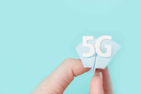 Flying paper plane with large white letters 5 G on blue background. Creative concept. Modern...