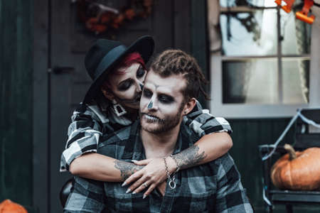 Scary love couple, man, woman.Family, mother, father celebrating halloween. Terrifying black skull...